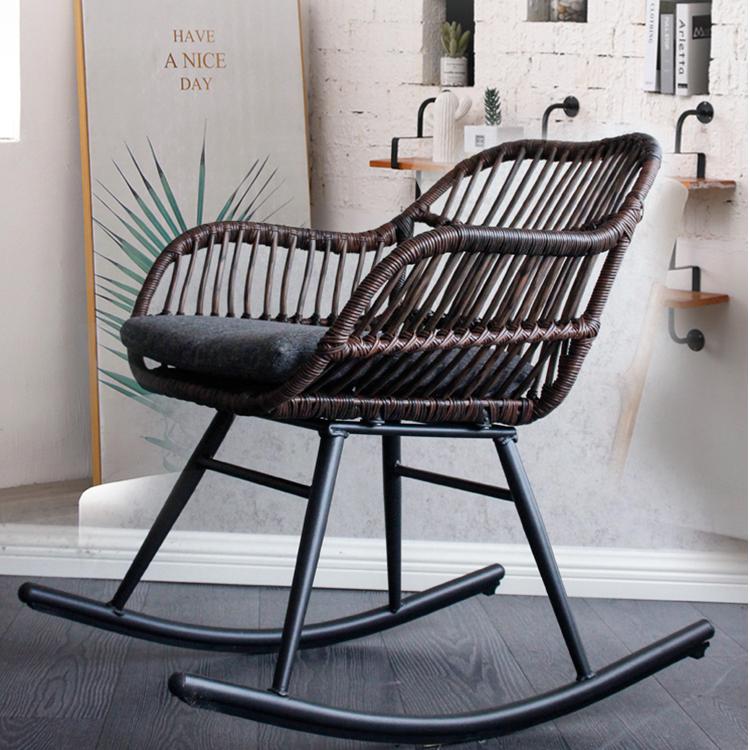 Rocking chair hand woven in deep brown rattan with a dense regular weave