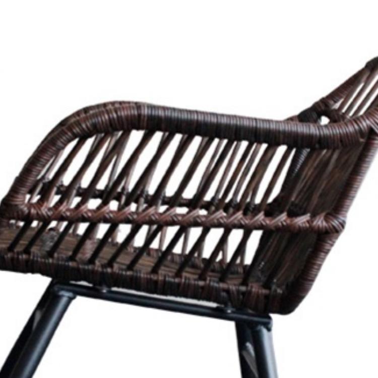 Rocking chair hand woven in deep brown rattan with a dense regular weave