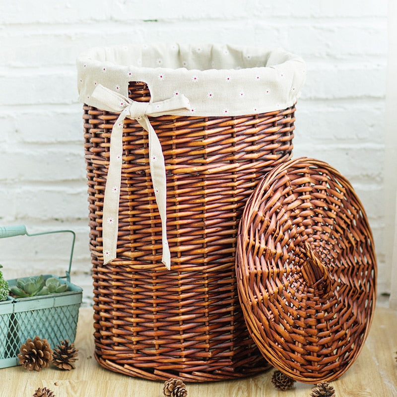 Tall dark brown wicker laundry hamper with lid and white liner