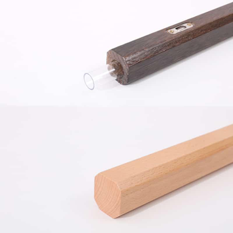 Slim dark wood wall vase holding a single stem