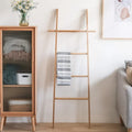 Tall decorative bamboo blanket ladder leaning against a wall