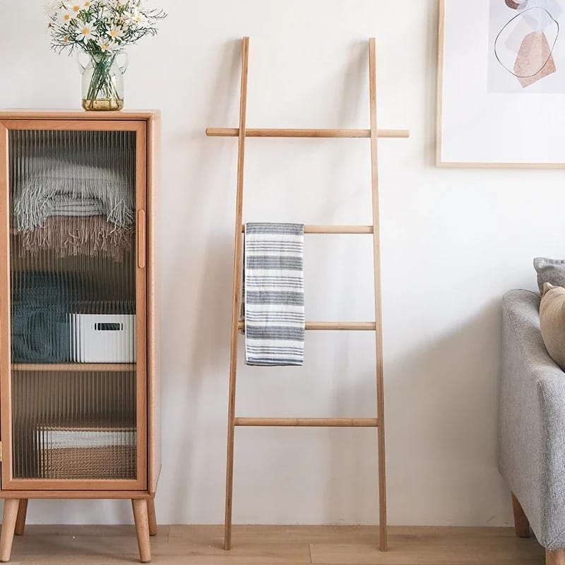 Tall decorative bamboo blanket ladder leaning against a wall