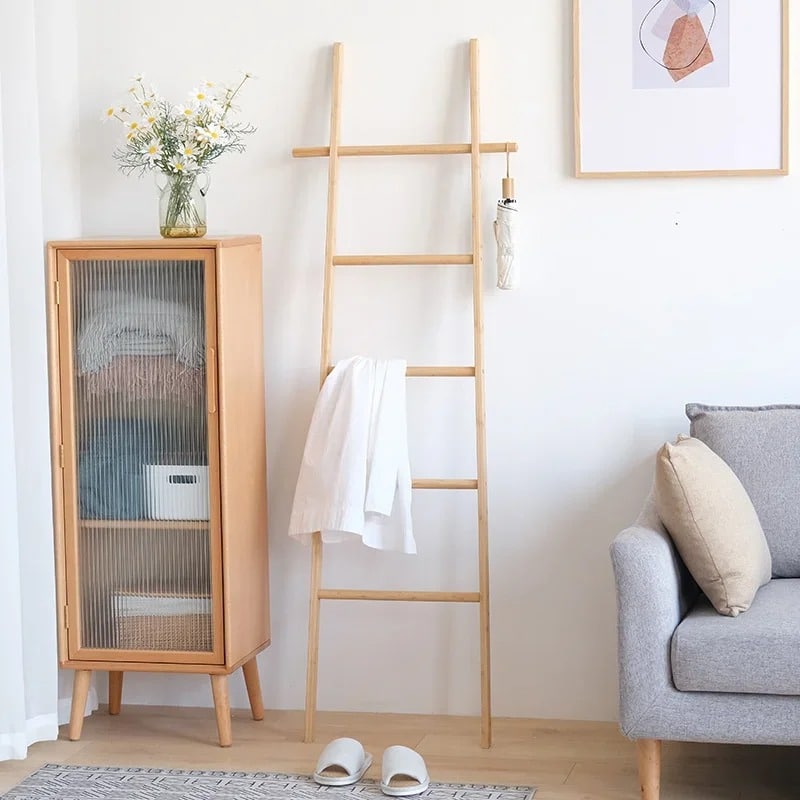 Tall decorative bamboo blanket ladder leaning against a wall