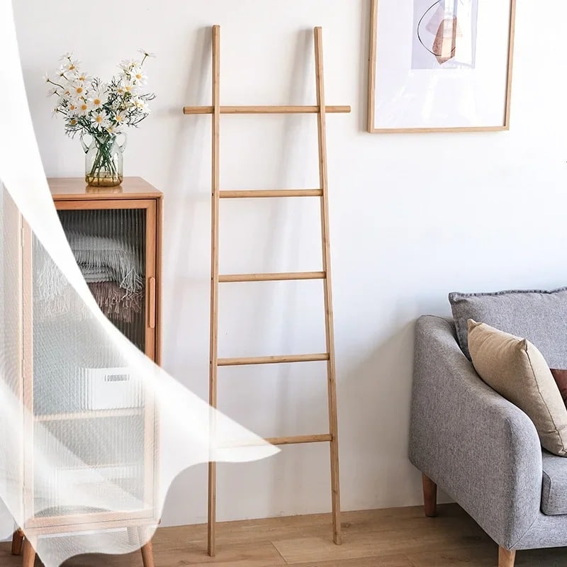 Tall decorative bamboo blanket ladder leaning against a wall