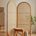 Two panel room divider with rounded oval tops in hand woven natural rattan