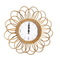 Round wall clock with a double rosette of rattan loops, 16.1 in. Battery operated, easy to read.