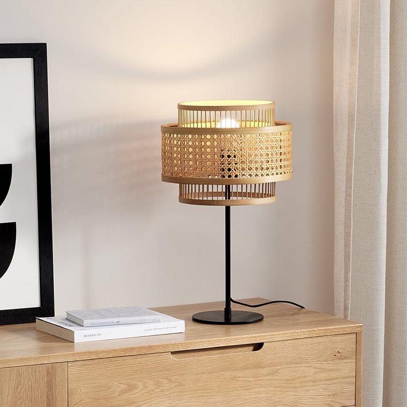 Sculptural floor lamp with two round hand woven rattan shades stacked on a bamboo frame