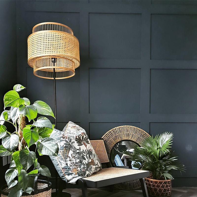 Sculptural floor lamp with two round hand woven rattan shades stacked on a bamboo frame