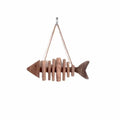 Fish shaped wall ornament made of driftwood pieces on a hanging cord