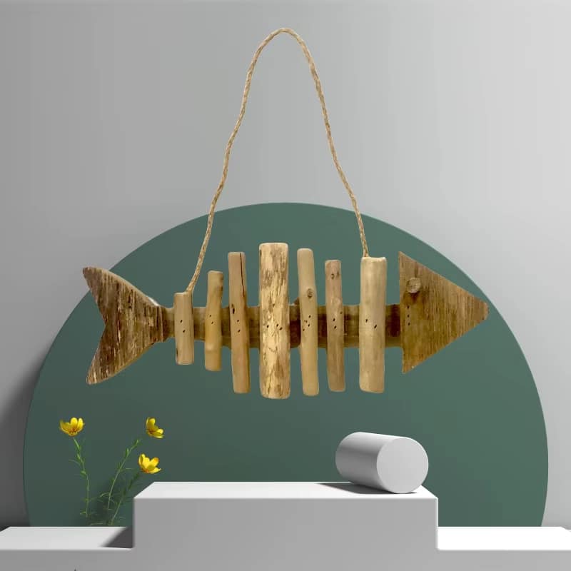 Fish shaped wall ornament made of driftwood pieces on a hanging cord