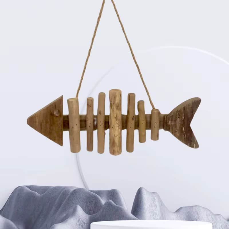 Fish shaped wall ornament made of driftwood pieces on a hanging cord