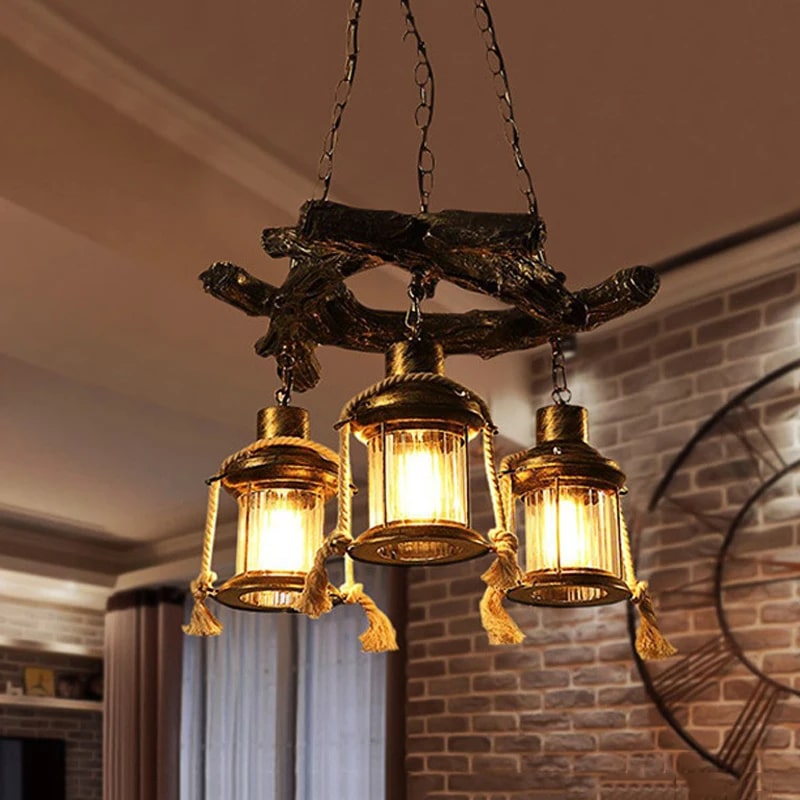 Long industrial pendant light with a gray driftwood look resin beam and iron fittings