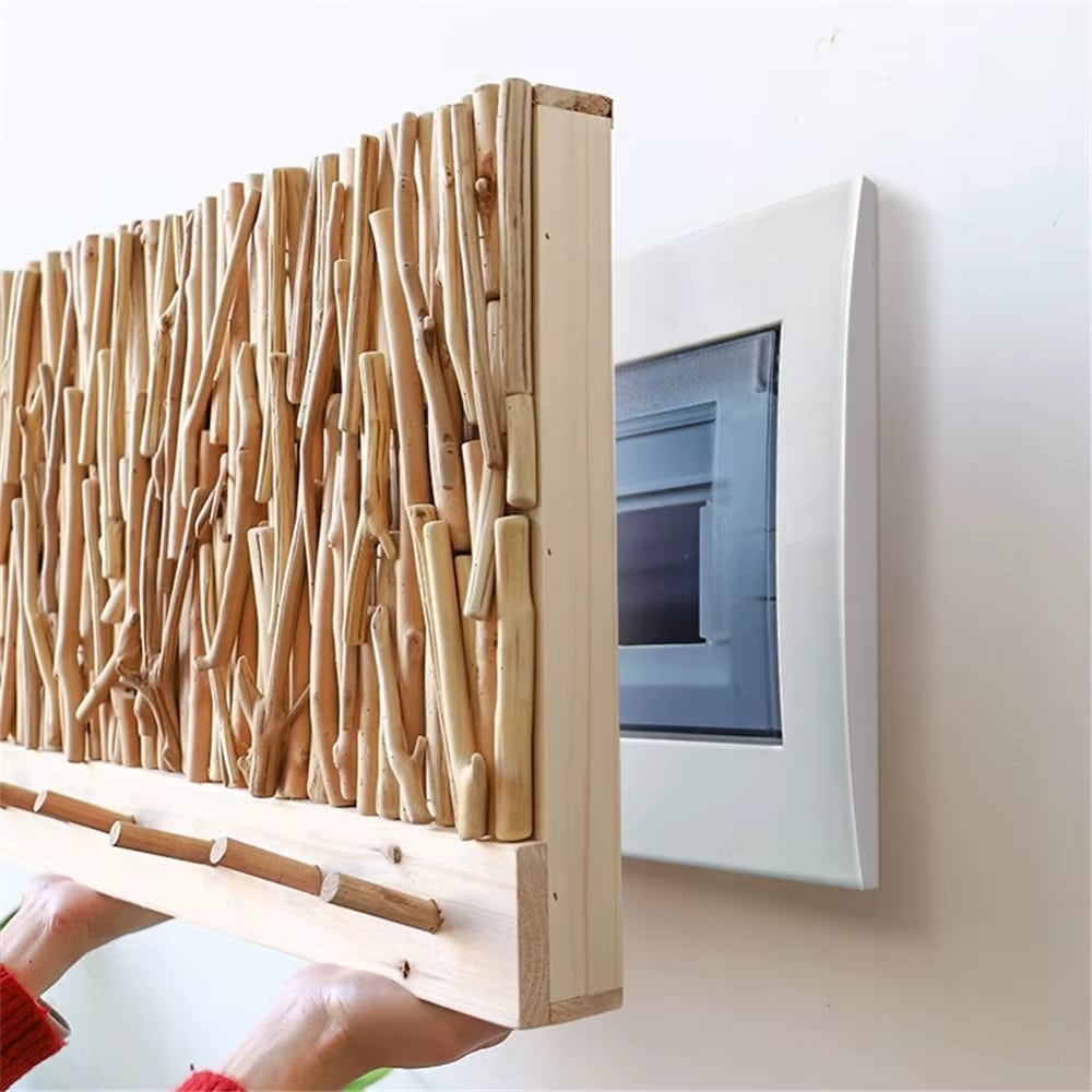 Wall coat rack made of natural driftwood sticks above a wood board with hooks