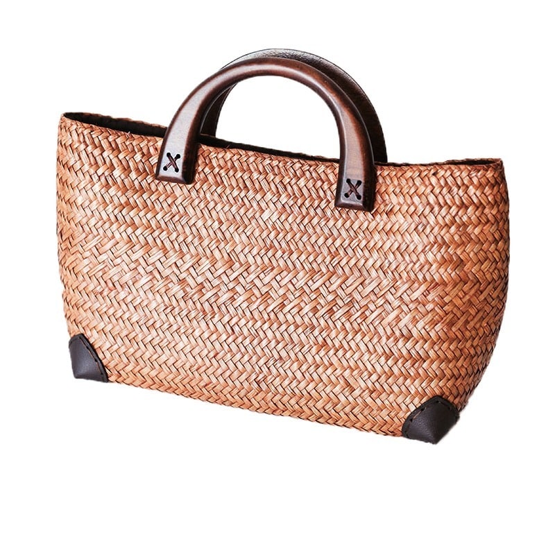 Hand woven rattan bag with polished wooden handles