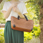 Hand woven rattan bag with polished wooden handles