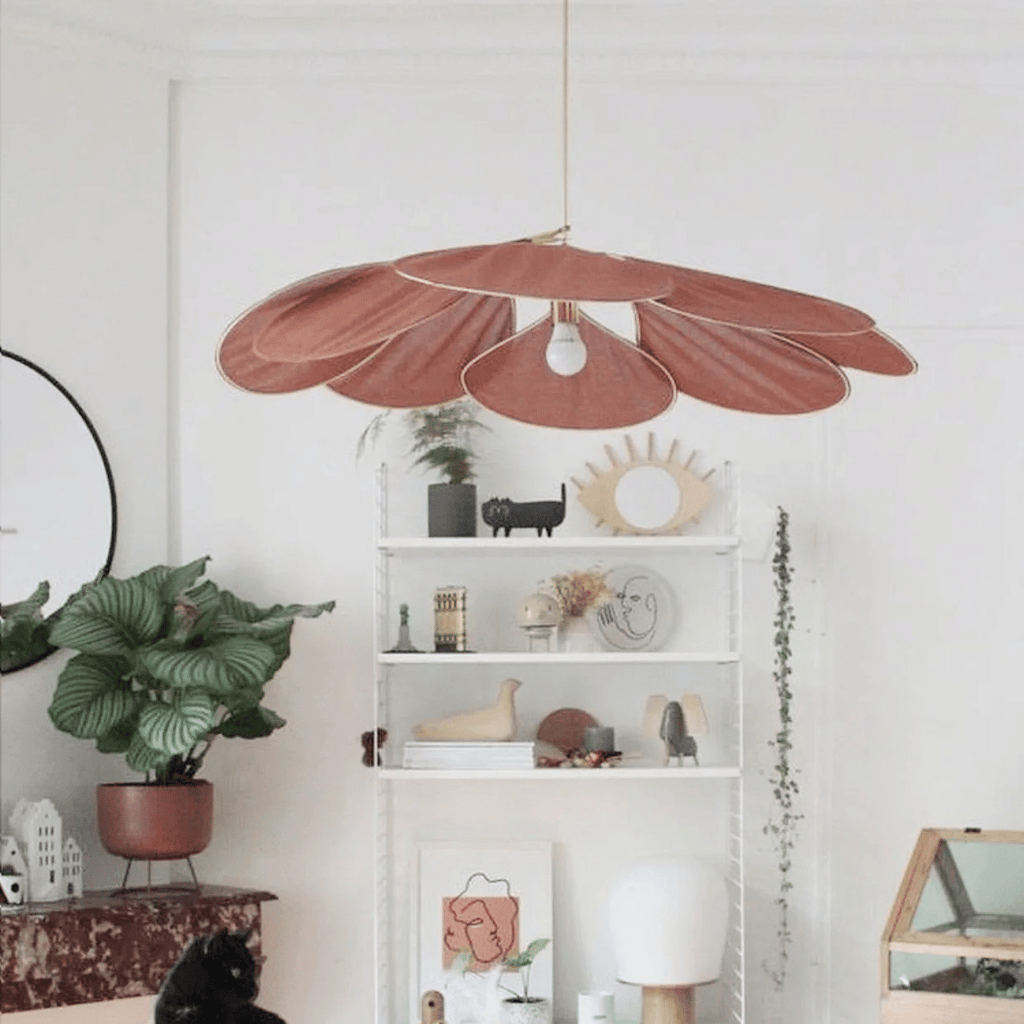 Large flower shaped fabric petal pendant light over a bed