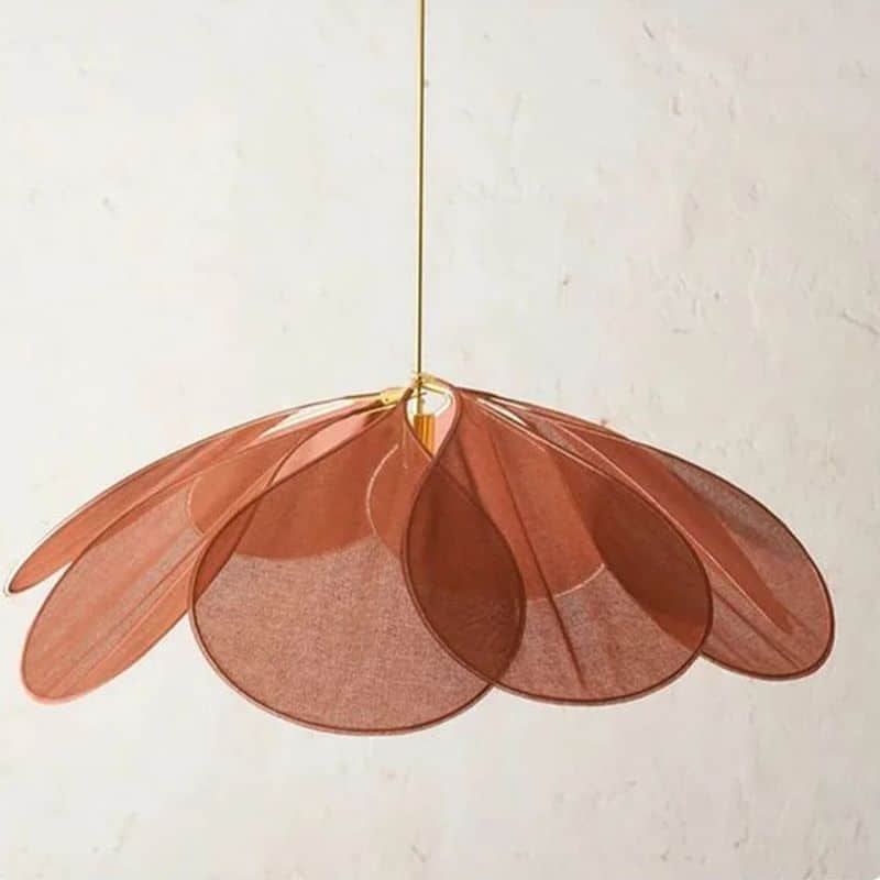 Large flower shaped fabric petal pendant light over a bed