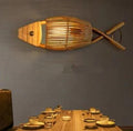 Fish shaped wall sconce hand woven in natural rattan