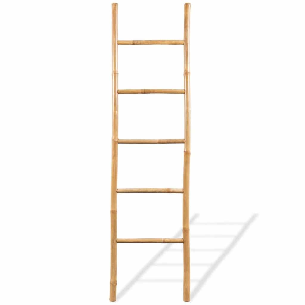 Five rung natural bamboo blanket ladder leaning against a wall