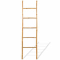 Five rung natural bamboo blanket ladder leaning against a wall