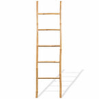 Five rung natural bamboo blanket ladder leaning against a wall