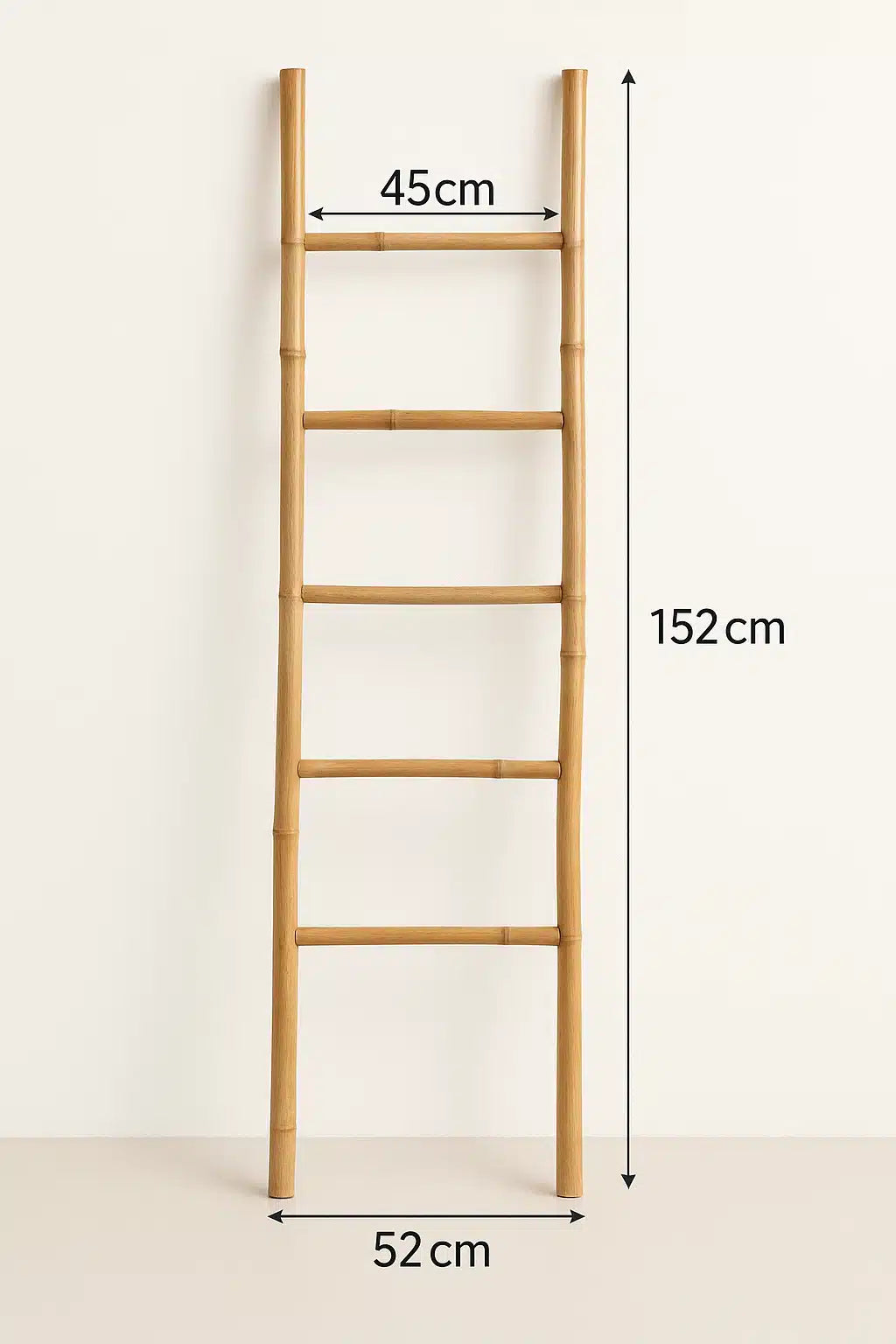 Five rung natural bamboo blanket ladder leaning against a wall