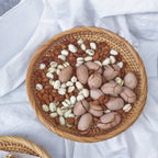 Flat round rattan basket holding nuts