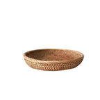 Flat round rattan basket holding nuts