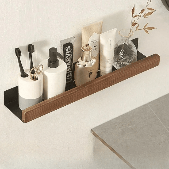 Slim floating wood ledge shelf with aluminum rail holding toiletries