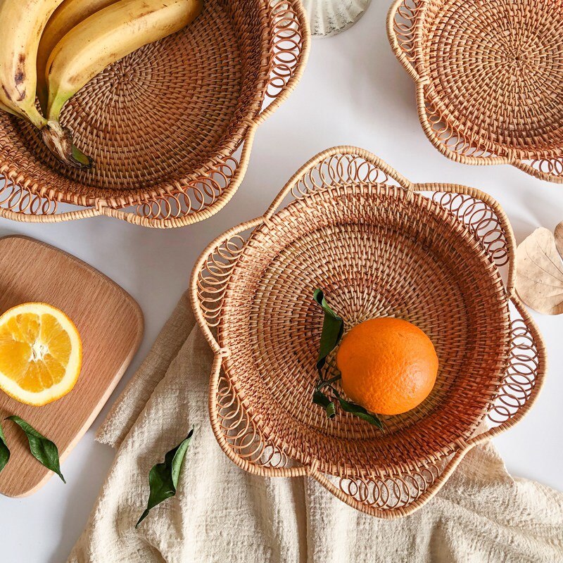 Flower shaped rattan fruit bowls holding oranges and bananas