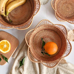 Flower shaped rattan fruit bowls holding oranges and bananas