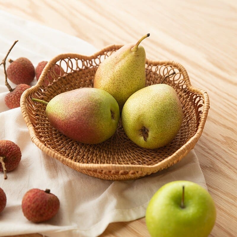 Flower shaped rattan fruit bowls holding oranges and bananas