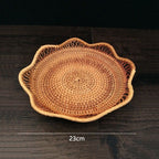 Flower shaped rattan fruit bowls holding oranges and bananas
