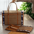 Suitcase style woven bamboo picnic basket with fabric trim and handles