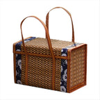Suitcase style woven bamboo picnic basket with fabric trim and handles