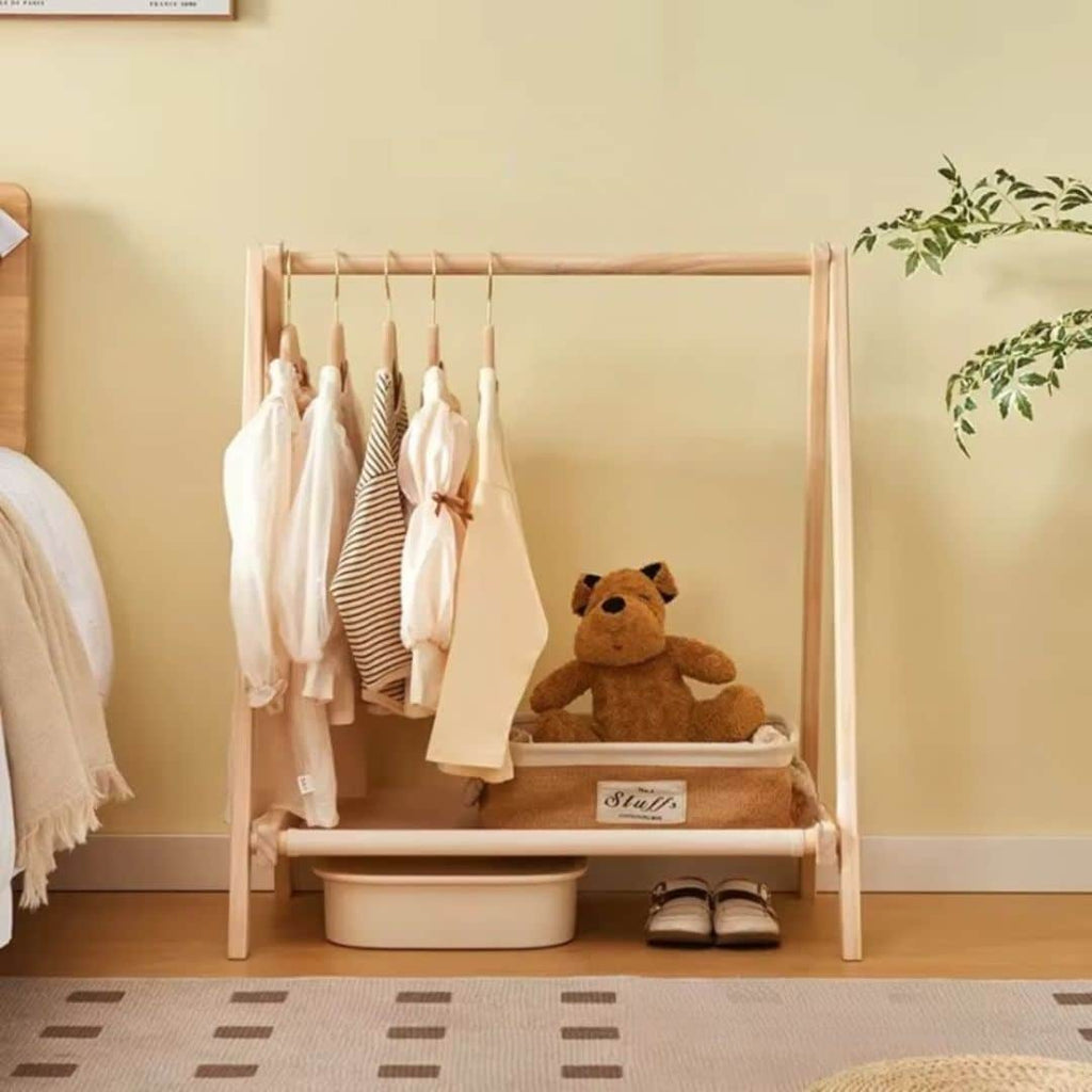 Folding modern clothes rack with a crossed light natural wood frame