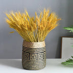 Round hand woven rattan planter with black geometric diamond pattern