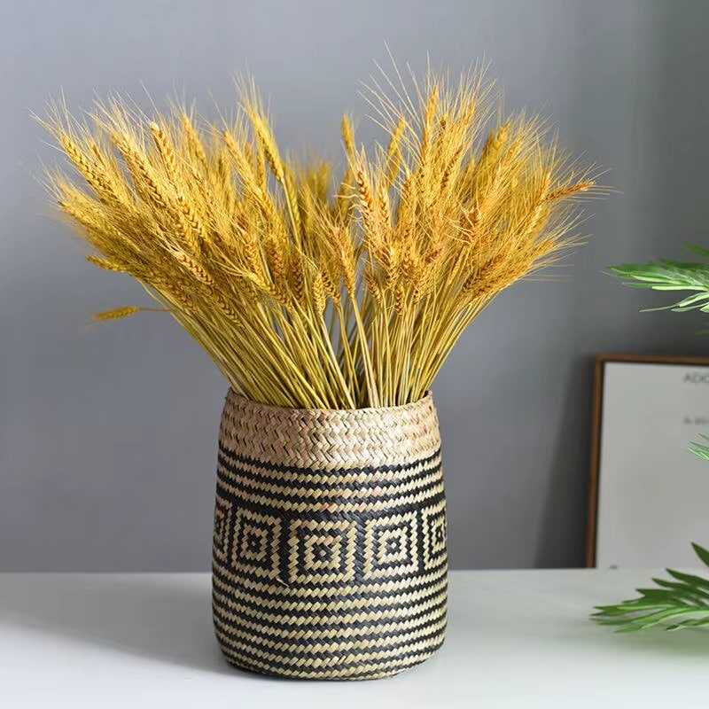 Round hand woven rattan planter with black geometric diamond pattern