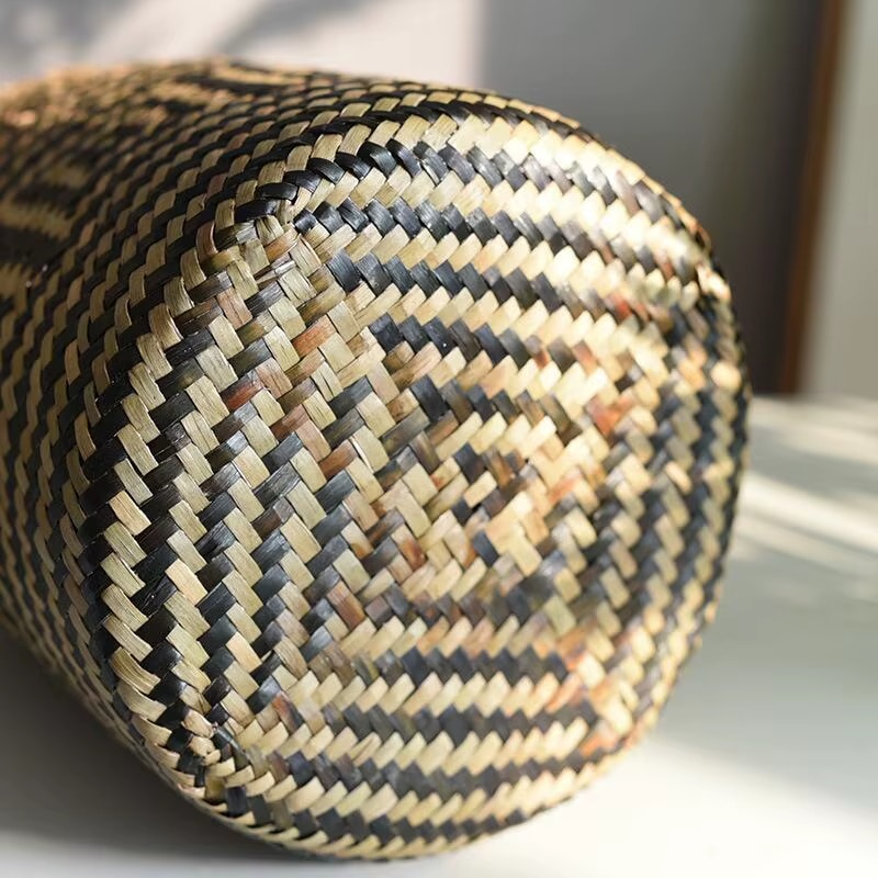 Round hand woven rattan planter with black geometric diamond pattern