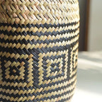 Round hand woven rattan planter with black geometric diamond pattern