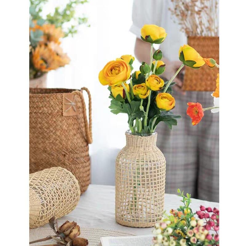 Glass vase in a woven rattan sleeve with a square pattern