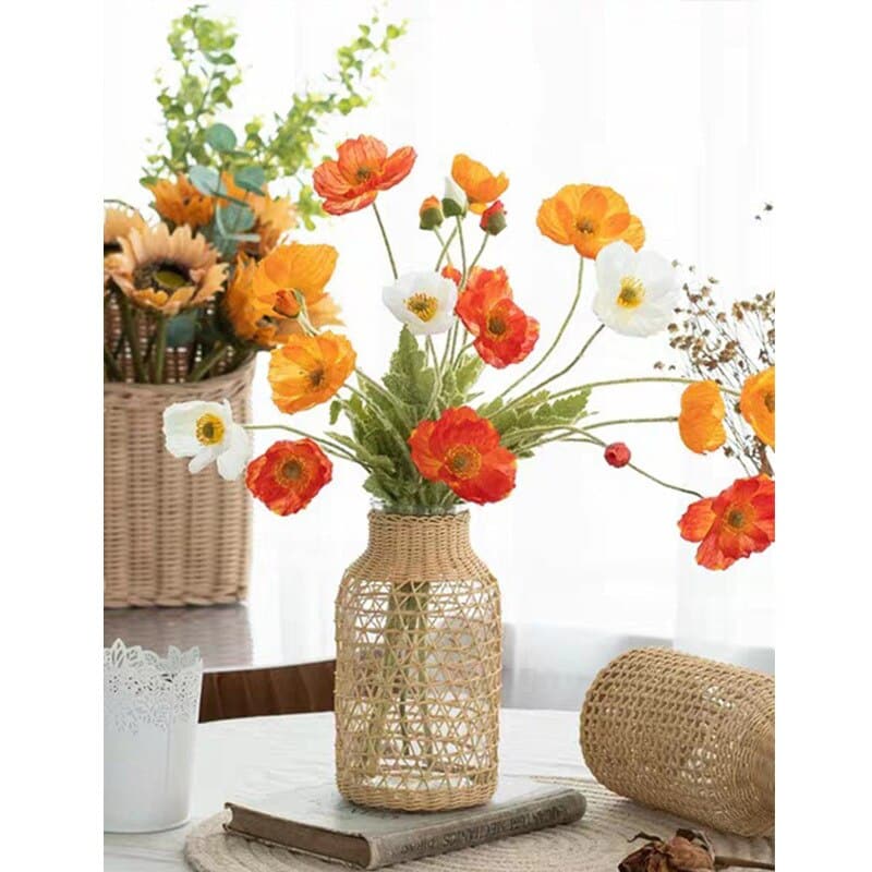 Glass vase in a woven rattan sleeve with a triangle pattern
