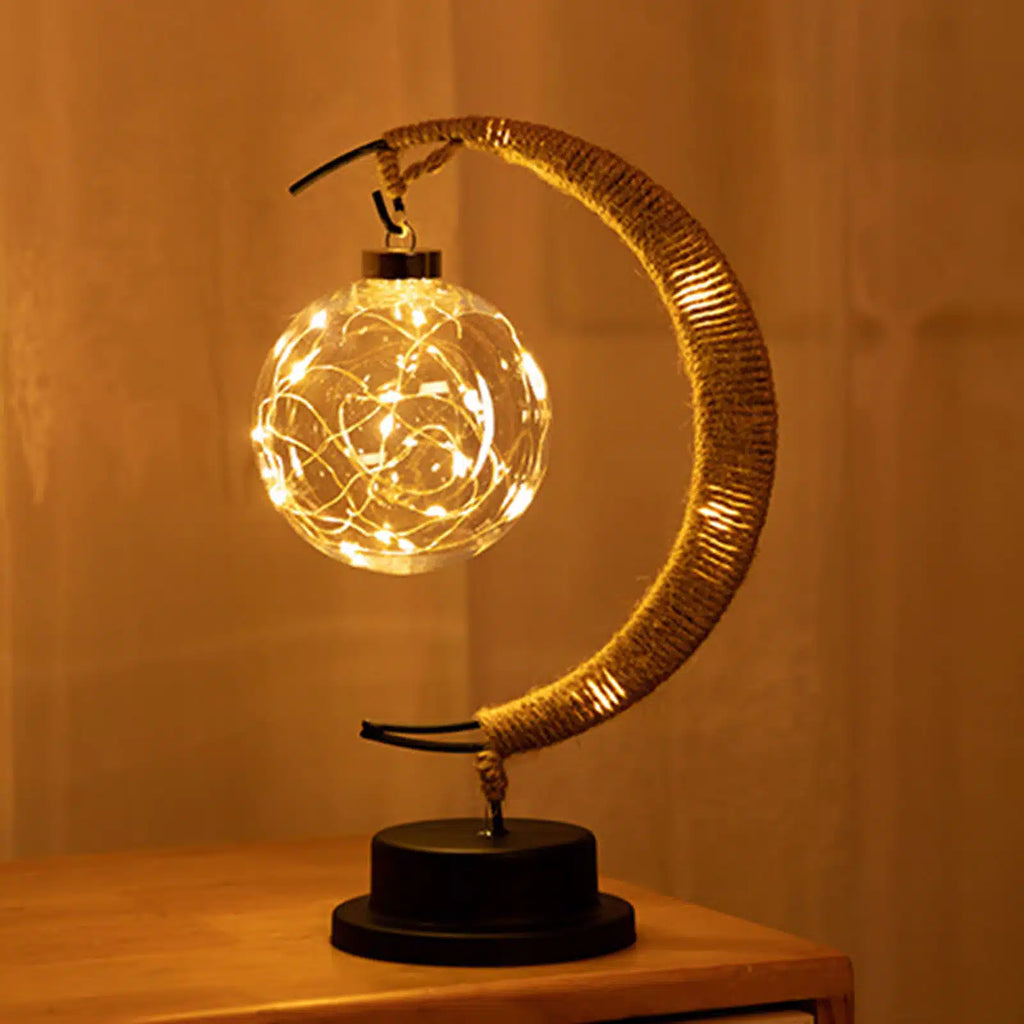 Crescent moon lamp with a hand woven hemp frame and a warm golden glow