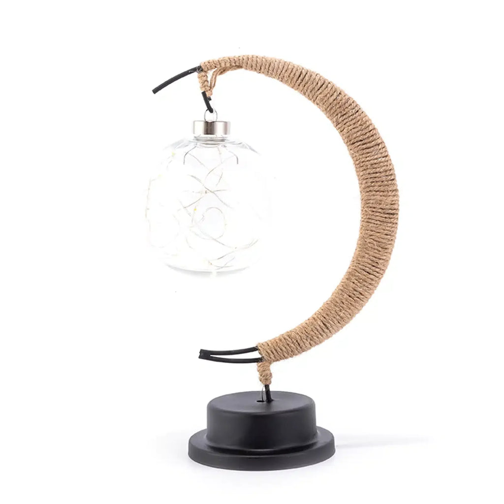 Crescent moon lamp with a hand woven hemp frame and a warm golden glow