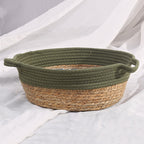 Round woven dog basket with green rim and patterned cushion