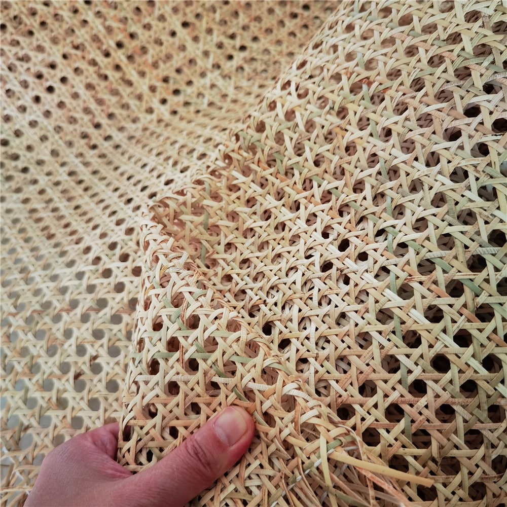 Roll of greenish rattan cane webbing with a round open mesh