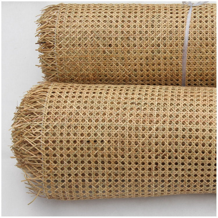 Roll of greenish rattan cane webbing with a round open mesh