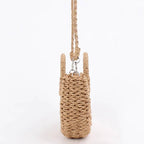 Brown half moon hand woven rattan crossbody bag with an adjustable strap