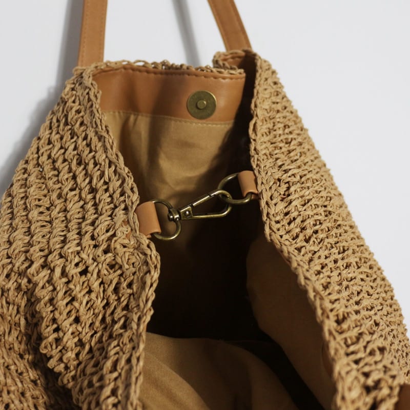 Hand woven straw handbag with a dense, even texture in brown or beige