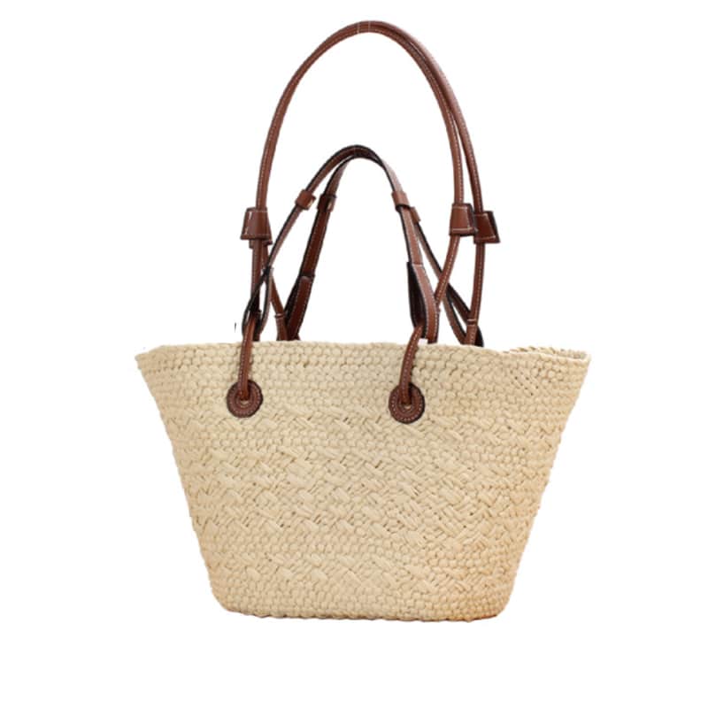 Beige hand woven straw tote with two tone brown handles and a crossbody strap